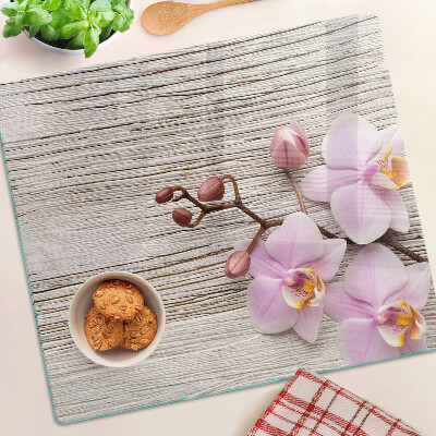 Glazen snijplanken Orchideeën op een houten achtergrond