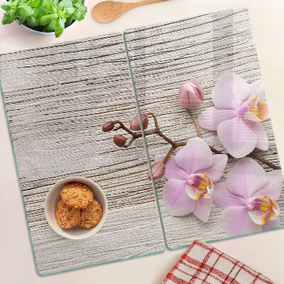 Glazen snijplanken Orchideeën op een houten achtergrond