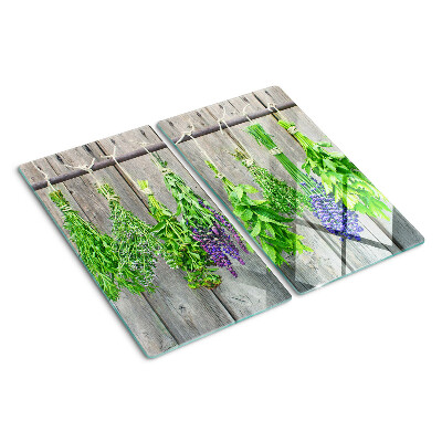 Glazen snijplanken Gedroogde kruiden op een houten achtergrond