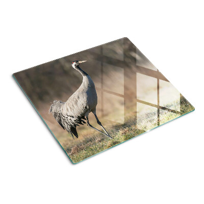 Snijplanken glas Een kraan tegen de achtergrond van een landschap