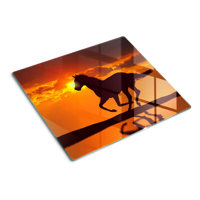 Glazen snijplanken Een paard tegen de achtergrond van de ondergaande zon