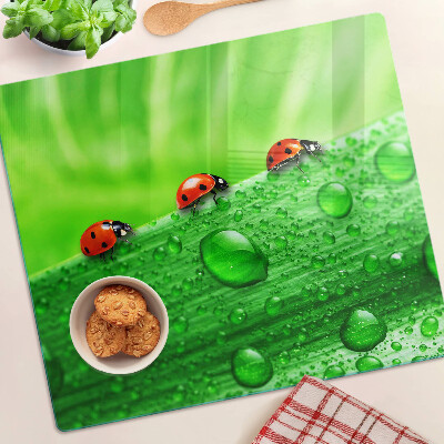 Glazen snijplanken Lieveheersbeestjes op een groene achtergrond