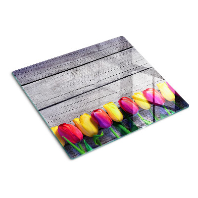 Glazen snijplanken Tulpen op een houten achtergrond