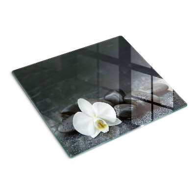 Snijplanken glas Orchideebloem op stenen