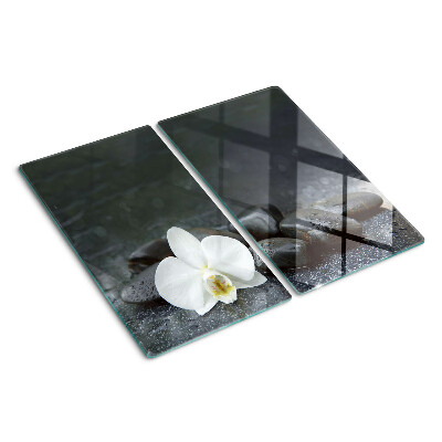Snijplanken glas Orchideebloem op stenen