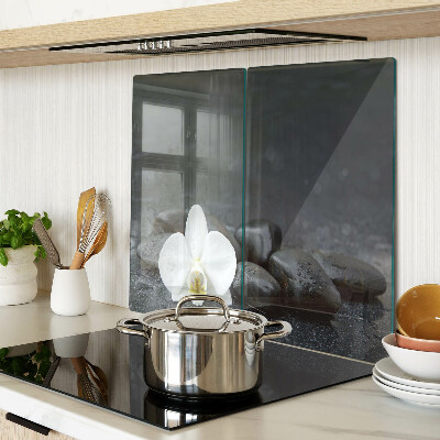 Snijplanken glas Orchideebloem op stenen