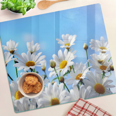 Snijplanken glas Madeliefjes op een blauwe achtergrond