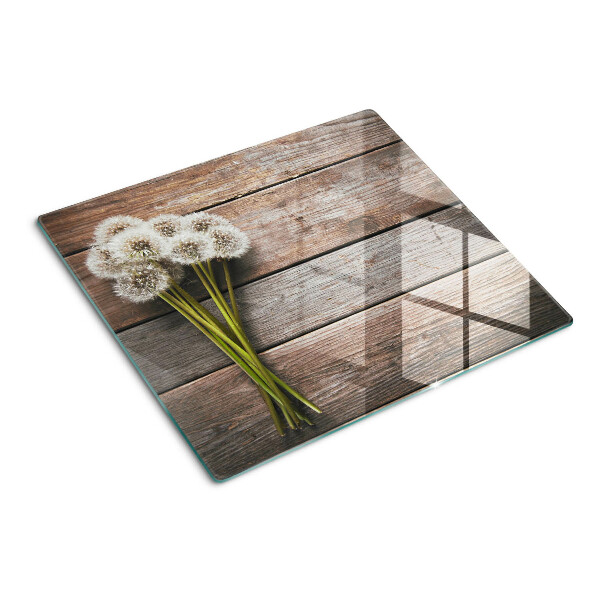 Snijplanken glas Paardenbloembloemen op een houten achtergrond