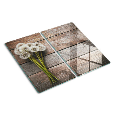 Snijplanken glas Paardenbloembloemen op een houten achtergrond