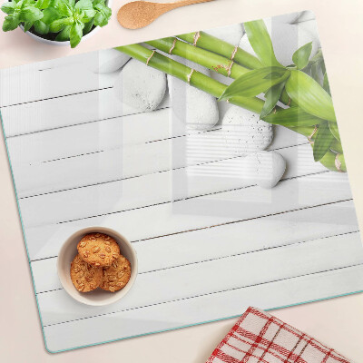 Snijplanken glas Bamboe en stenen op een houten achtergrond