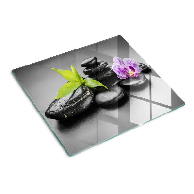 Snijplanken glas Stenen en orchidee op de achtergrond