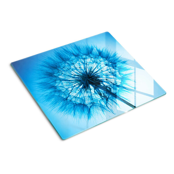 Glazen snijplanken Paardenbloem op een blauwe achtergrond