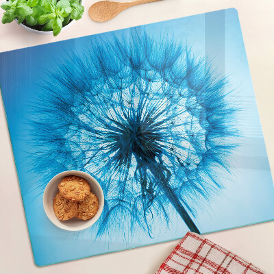 Glazen snijplanken Paardenbloem op een blauwe achtergrond