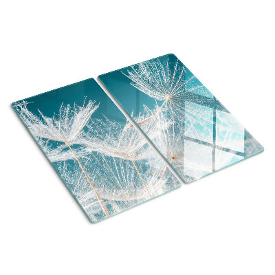 Glazen snijplanken Paardenbloemen op een blauwe achtergrond