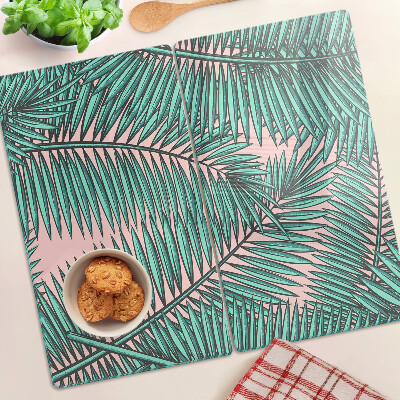 Snijplanken glas Palmbladeren op een roze achtergrond