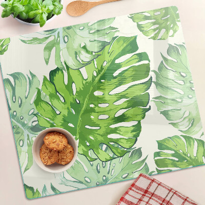 Snijplanken glas Monsterabladeren op een lichte achtergrond