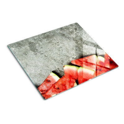 Snijplanken glas Watermeloenschijfjes op een grijze achtergrond