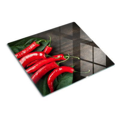 Snijplanken glas Chilipepers op een houten achtergrond