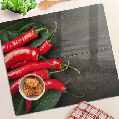 Snijplanken glas Chilipepers op een houten achtergrond