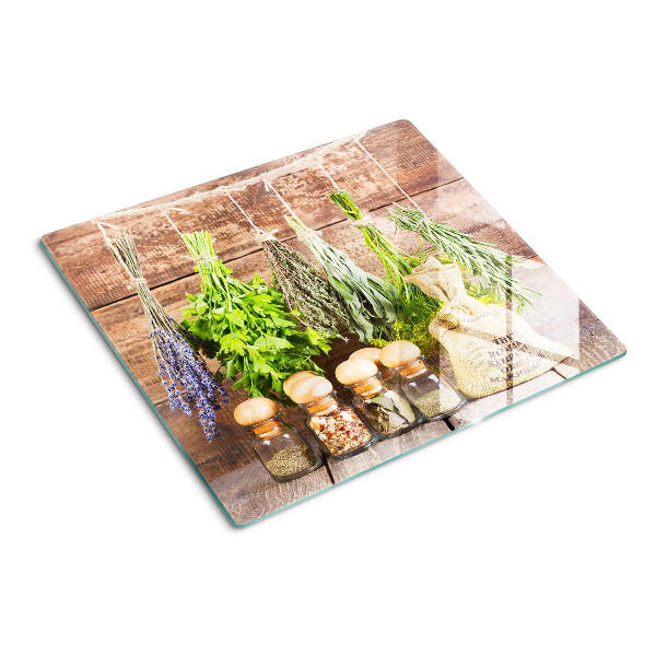 Glazen snijplanken Kruiden en specerijen op een houten achtergrond