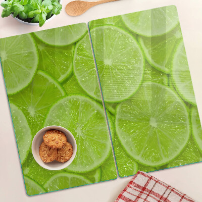 Glazen snijplanken Limoenschijfjes op een groene achtergrond