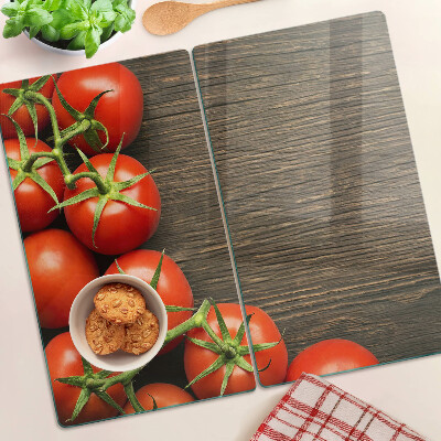 Glazen snijplanken Tomaten op een houten achtergrond