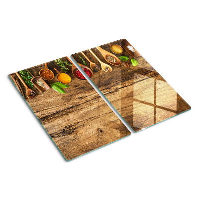 Snijplanken glas Specerijen en kruiden op een houten achtergrond