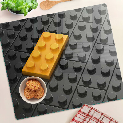 Glazen snijplanken LEGO-stenen op een zwarte achtergrond
