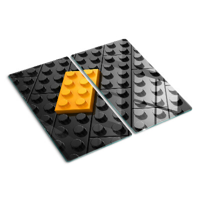 Glazen snijplanken LEGO-stenen op een zwarte achtergrond