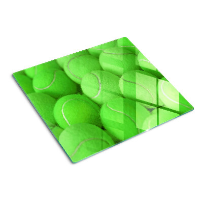Glazen snijplanken Tennisballen op een groene achtergrond