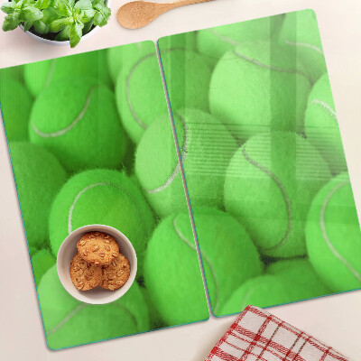 Glazen snijplanken Tennisballen op een groene achtergrond