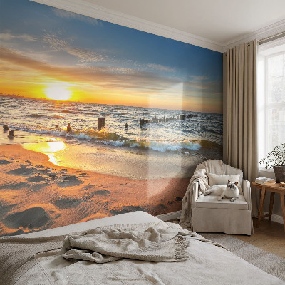 Foto behang voor de kinderkamer met een zonsondergang op het strand