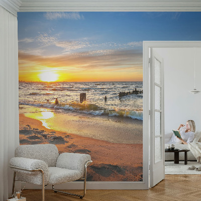 Foto behang voor de kinderkamer met een zonsondergang op het strand
