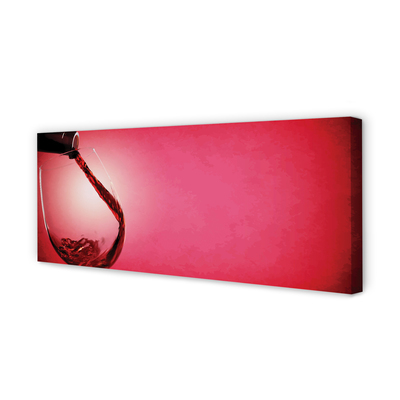 Canvas doek foto Rode achtergrond met een glas over