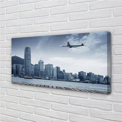 Schilderijen op canvas doek Vliegtuig stadswolken