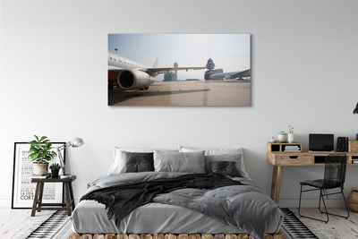 Schilderij op glas Vliegtuig gebouwen luchthaven lucht