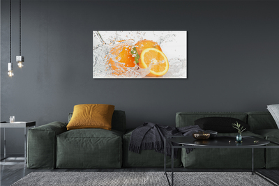 Schilderij op glas Sinaasappelen in water