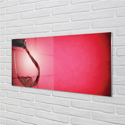 Spatplaat keuken glas Rode achtergrond met een glas over