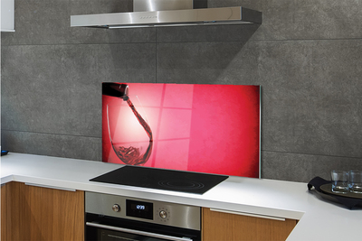 Spatplaat keuken glas Rode achtergrond met een glas over