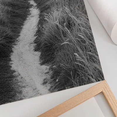 Decoratieve poster Een vuurtoren tegen de achtergrond van hoog gras.