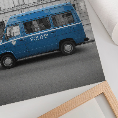 Poster Een blauwe politieauto met een gebouw op de achtergrond.