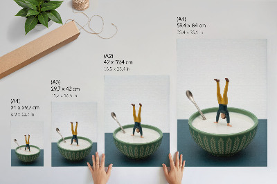 Wandposter Figuurtje in een kom melk met groene bladeren