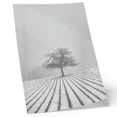 Wandposter boom in de sneeuw met een minimalistisch winterlandschap