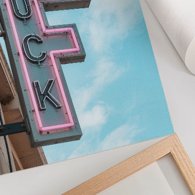 Poster Neon retro reclamebord met intense kleuren in een blauwe lucht.