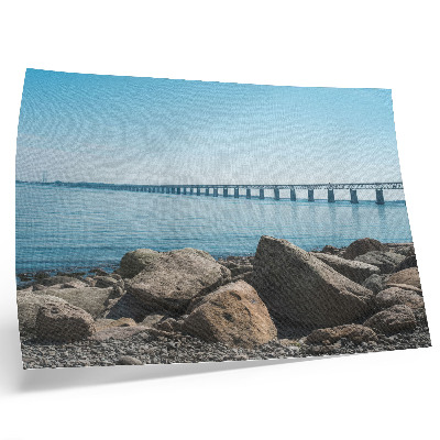Poster Brug over blauw water, stenen aan de oever