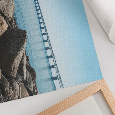 Poster Brug over blauw water, stenen aan de oever
