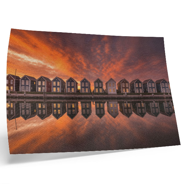 Poster Kleurrijke huizen aan het water in het licht van de zonsondergang.