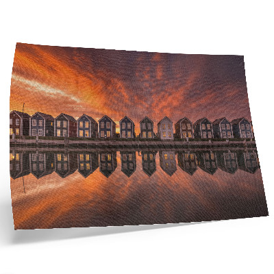 Poster Kleurrijke huizen aan het water in het licht van de zonsondergang.