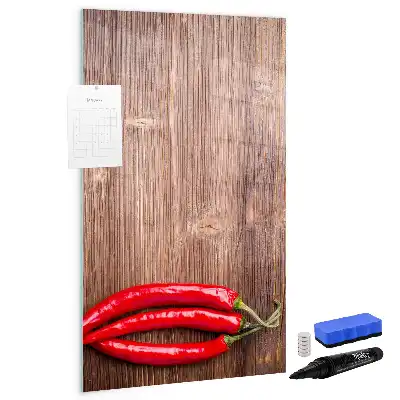 Magnetisch glazen memobord met afbeelding van chilipepers op een houten plank