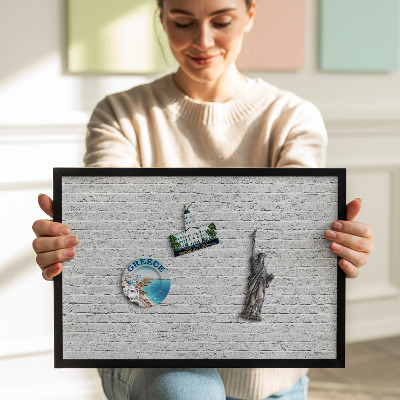 Magnetisch bord met zwarte rand Bakstenen muur, lichte muur
